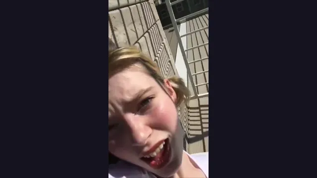 Blonde woman masturbating her pink vagina in broad daylight